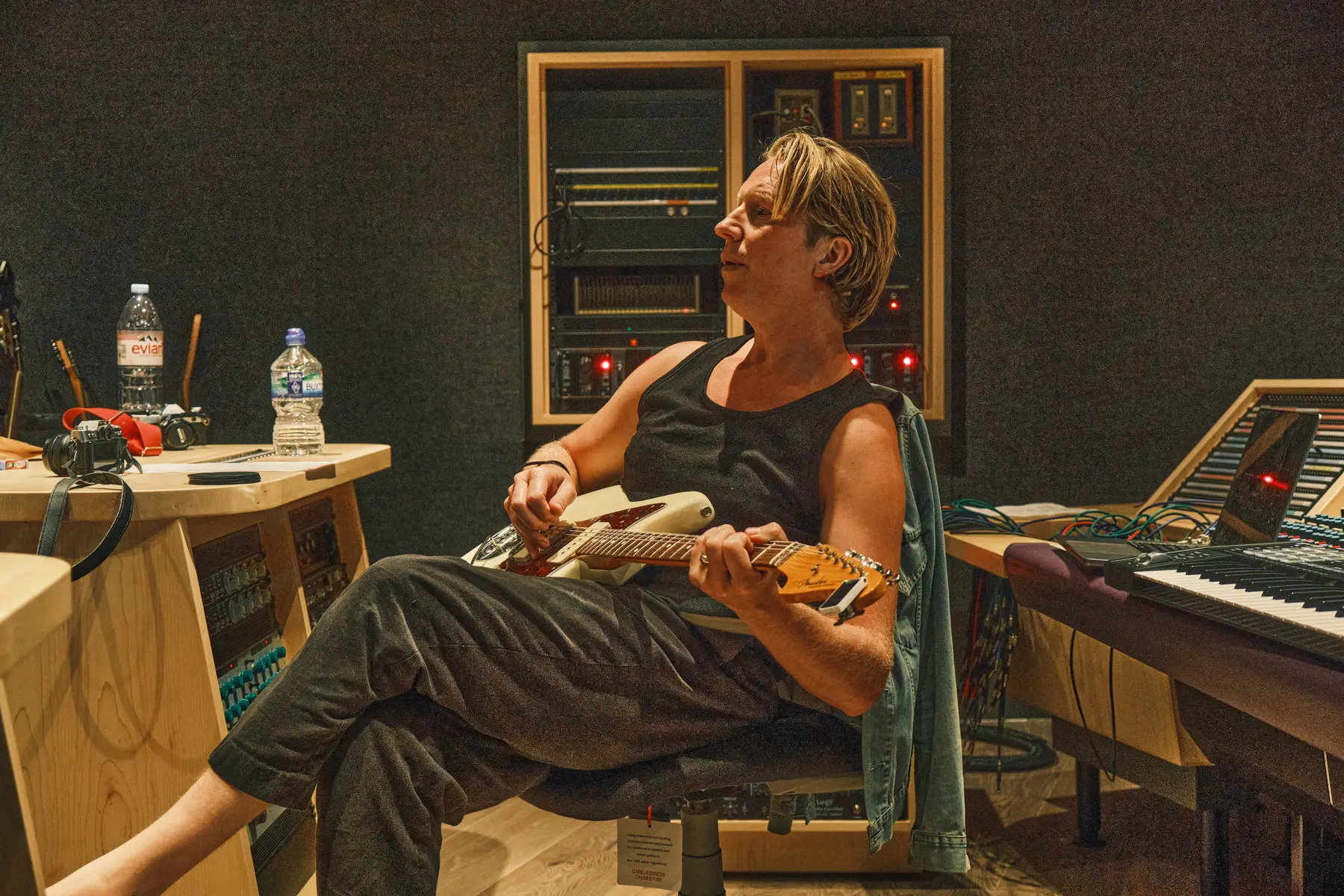 Guitarist seated in the Salvation Studios control room