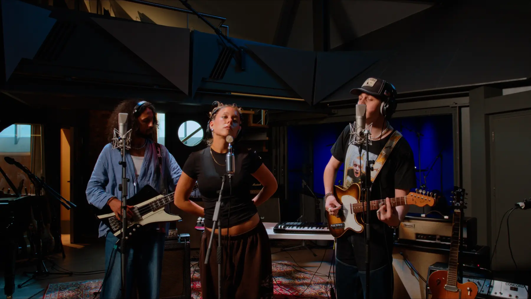 Three musicians performing together at Salvation Studios