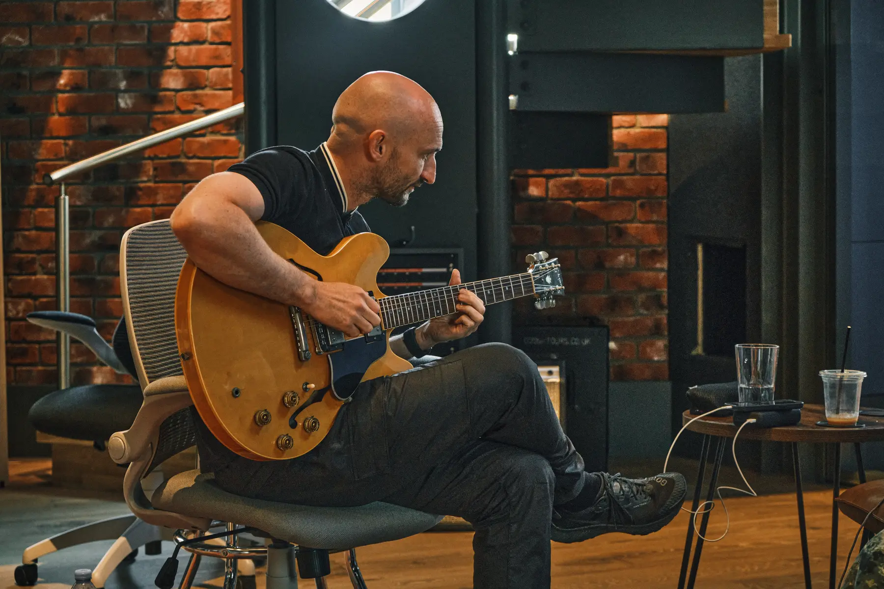 Guitarist playing a semi-hollow electric guitar at Salvation Studios