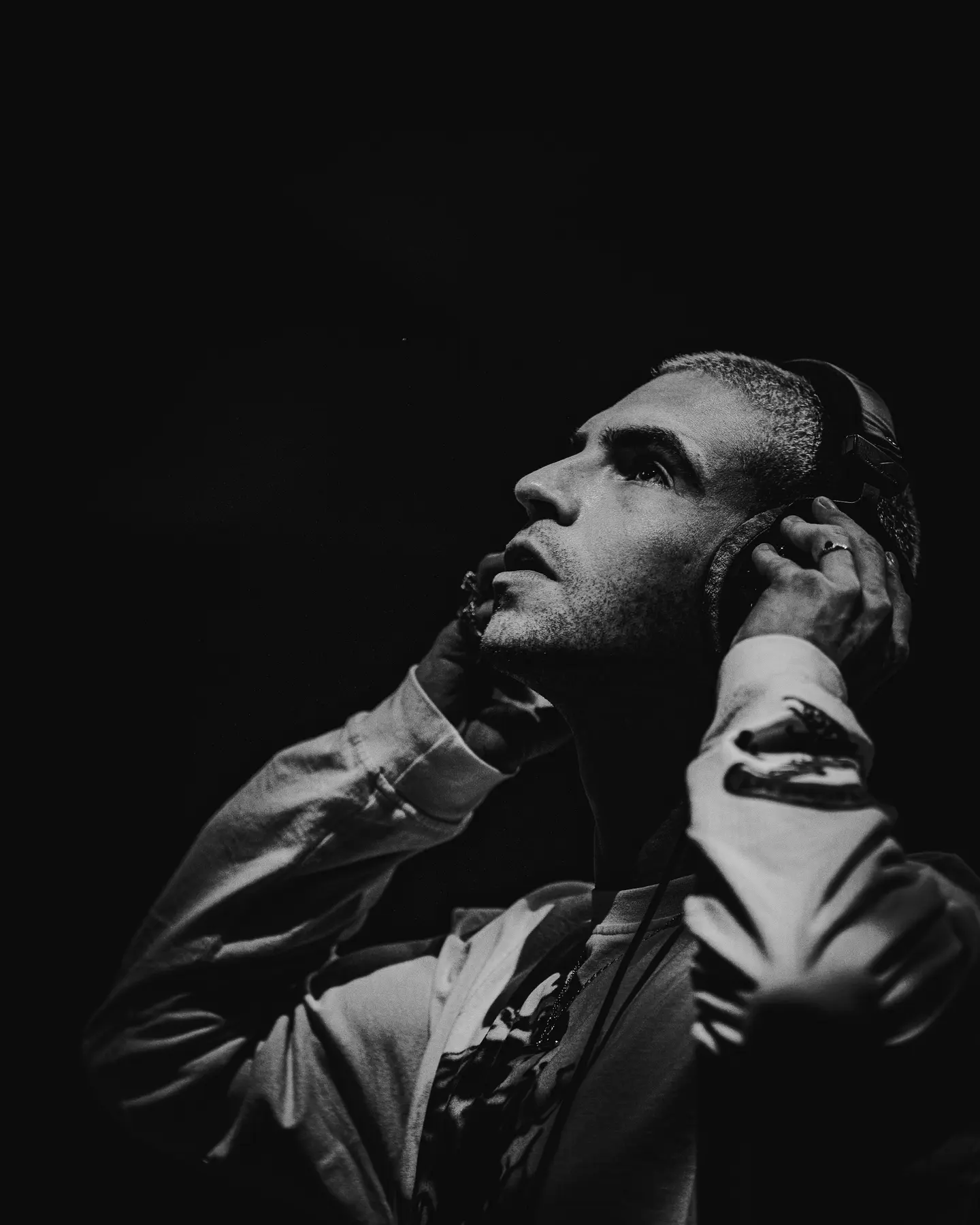 Black-and-white portrait of a musician wearing headphones
